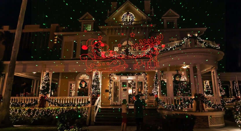 Christmas laser light projector creating a colorful festive holiday light display